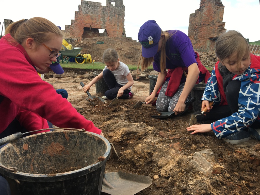Children excavating soil from a demolished wall in the ruins of Bradgate House, the birthplace of Lady Jane Grey.